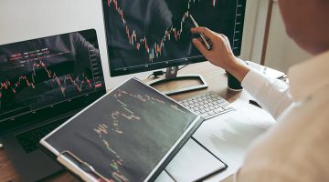 Investor man analyzing the graph of the stock market