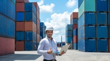 Shipping officer holding laptop