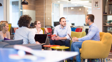 Group of a young business people discussing business plan at modern startup