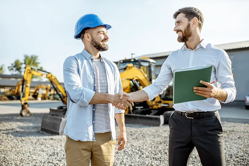 Builder shaking hands with his contractor