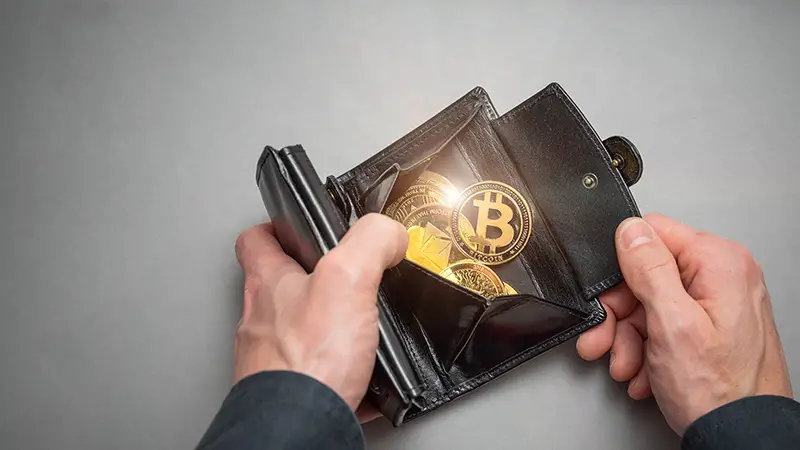 Cryptocurrency coin bitcoin in a black wallet