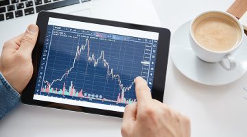 Investor watching the change of stock market on tablet