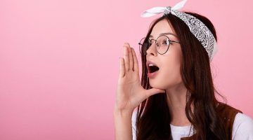 Young woman shouting with mouth slightly wide open