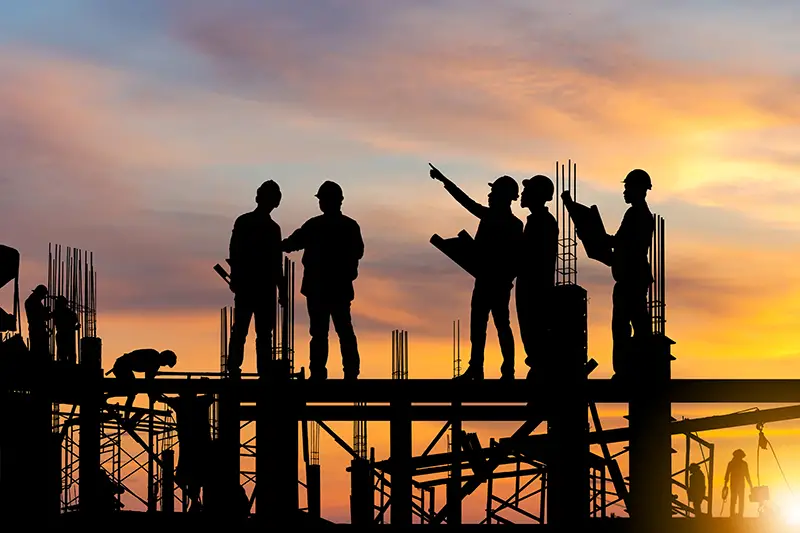 Silhouette of Engineer and worker on building site