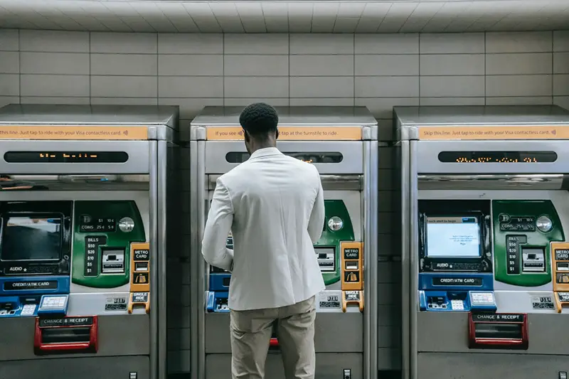 Man standing in front of ATM