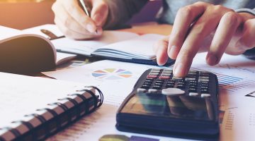 Hand man doing finances and calculate on desk