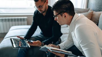 Businessmen staring at trading graph on black tablet android