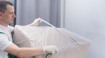Working courier measuring the bulky cargo