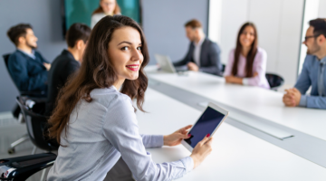 Woman employee smiling while inside the meeting room in the office