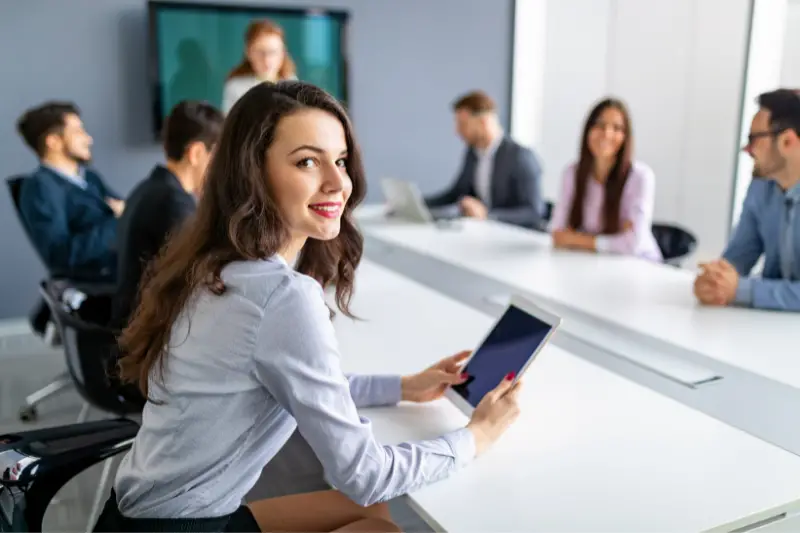 Woman employee smiling while inside the meeting room in the office