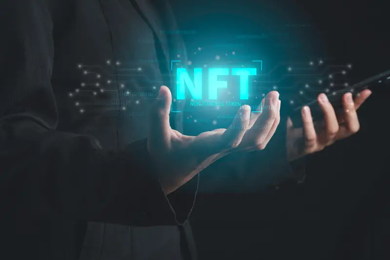 NFT neon text on businessman hands