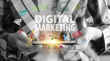 business holding a smart phone with DIGITAL MARKETING text