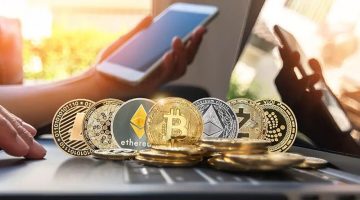 Bitcoins near the person holding mobile phone