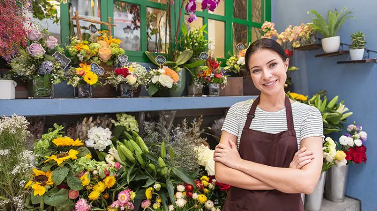 small business entrepreneur owne standing with flowers at florist shop