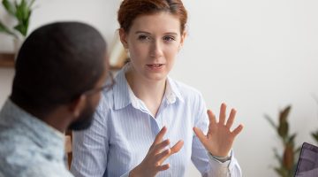 Man and woman colleagues talking in their work