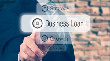 Businessman pressing a Business Loan concept button.