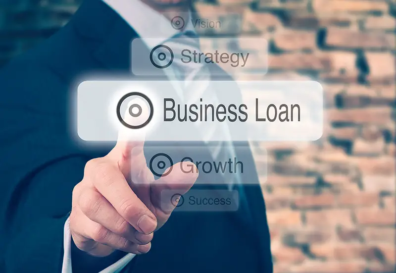 Businessman pressing a Business Loan concept button.