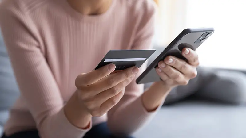 Woman using card paying online