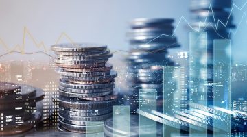 Double exposure of graph and rows of coins for finance and business concept