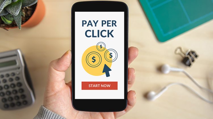 Hand holding smart phone with Pay Per Click (PPC) concept