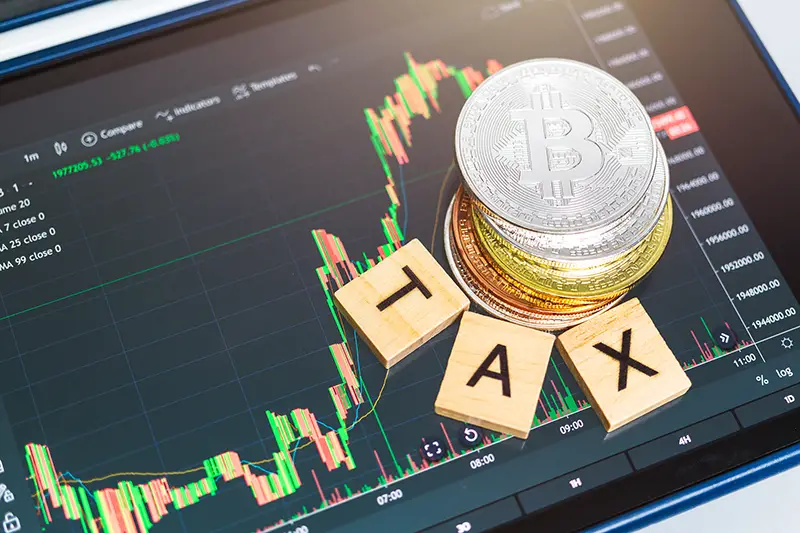 Cryptocurrencies with TAX word and stock chart 
