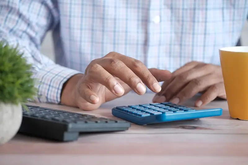 Man using blue calculator