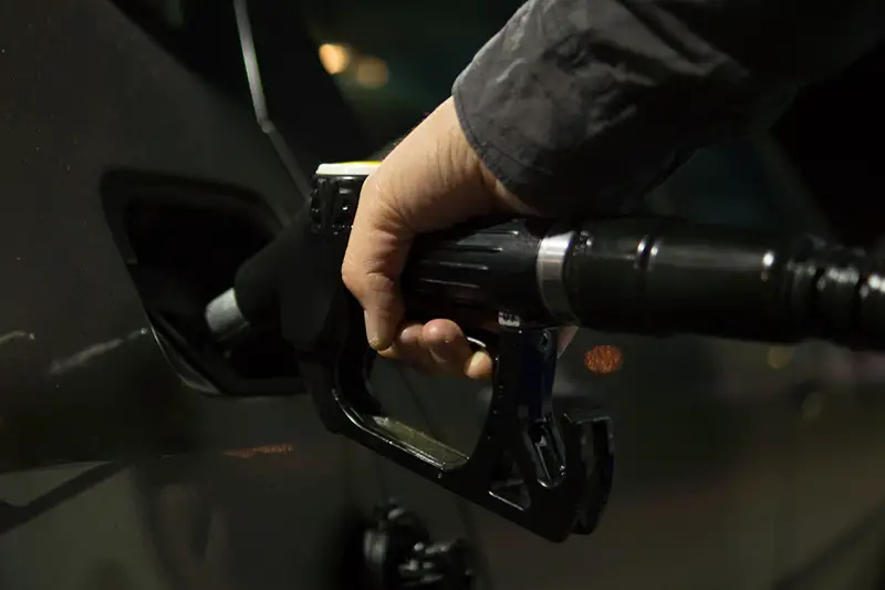 Person holding gasoline nozzle
