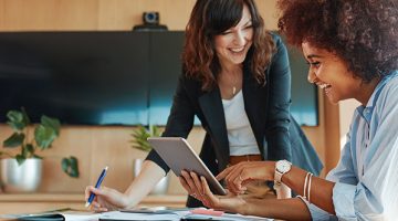Shot of two businesswoman working together on digital tablet.