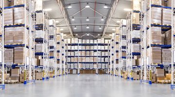 Huge distribution warehouse with high shelves and forklift