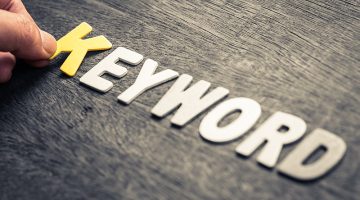 Hand place wood letters for KEYWORD concept