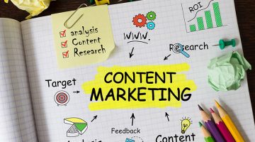 Handwriting of Content Marketing word in notebook on the wood table