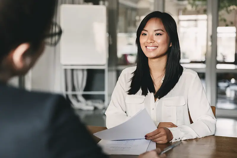 Smiling young woman in front of interviewer