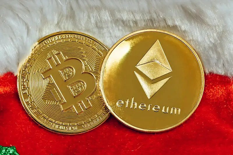 Bitcoin and Ethereum coin on top of a Christmas background