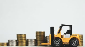 Tractor toy and pile of coins