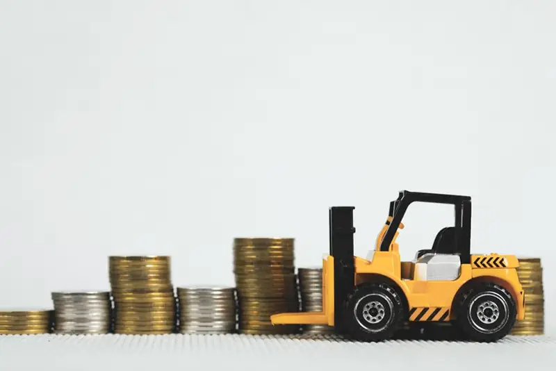 Tractor toy and pile of coins