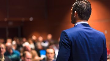 Speaker giving a talk on corporate Business Conference.
