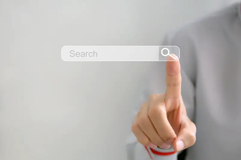 Person pointing on search bar