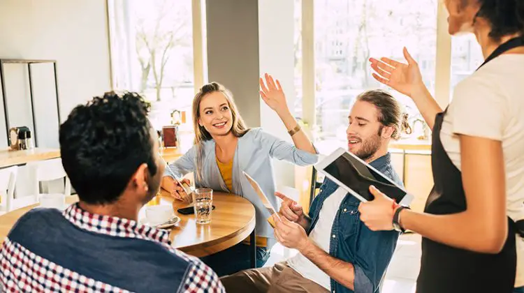 Waitress taking orders from clients