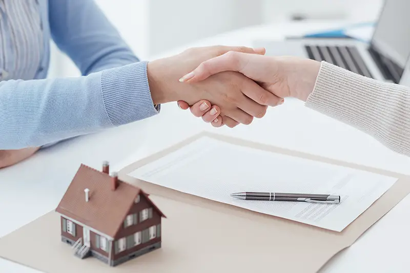 Property consultant handshake with her client