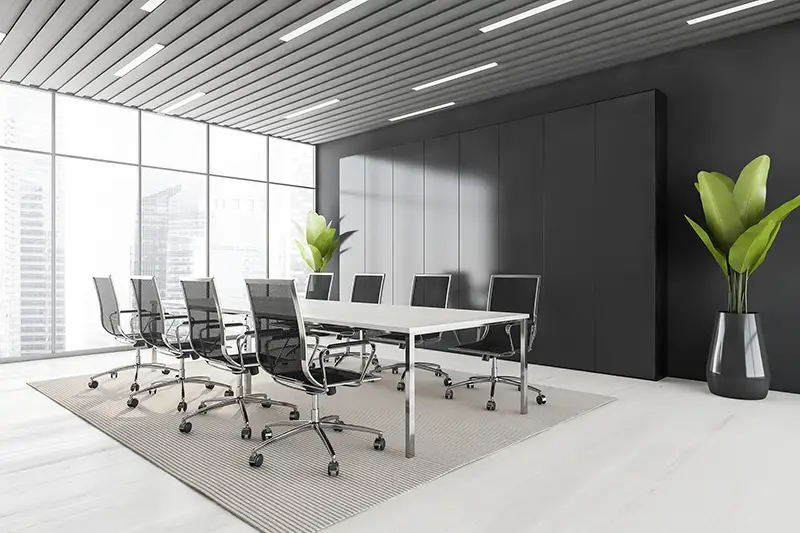 Business meeting room with black armchairs and white table