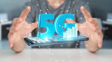 Businessman on blurred background using 5G network with mobile phone 3D rendering