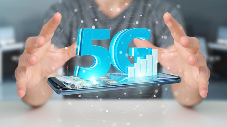 Businessman on blurred background using 5G network with mobile phone 3D rendering