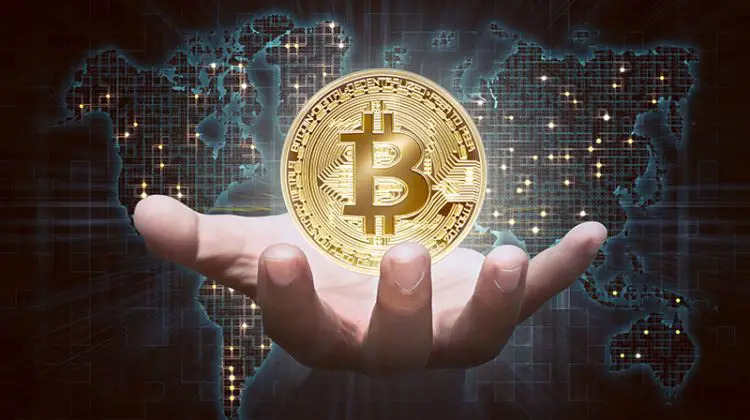 Man hands showing golden bitcoin as virtual money on digital world map background