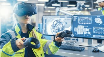 Female Industrial Engineer Wearing Virtual Reality Headset and Holding Controllers,