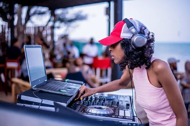 Female DJ wearing a hat