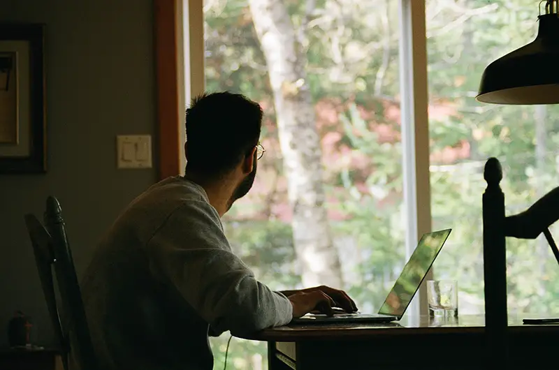Man working from his home sitting near window