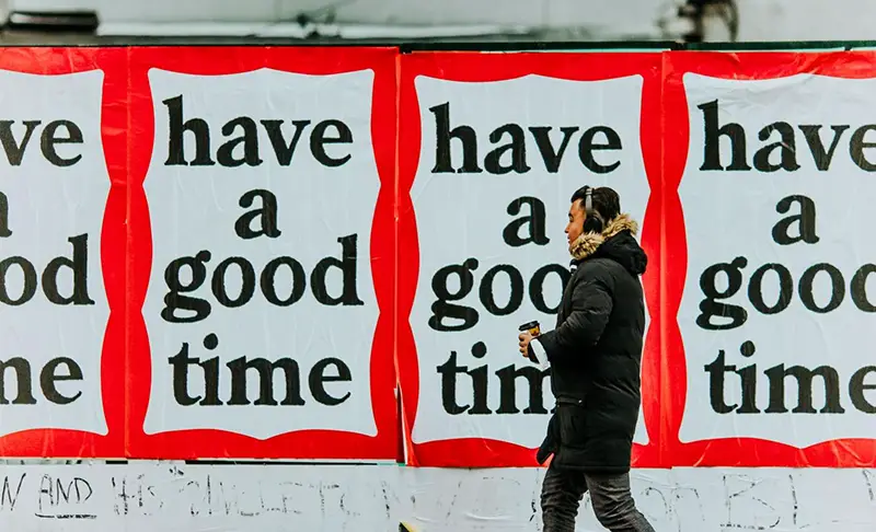 Man walking in the street with print banner on the background