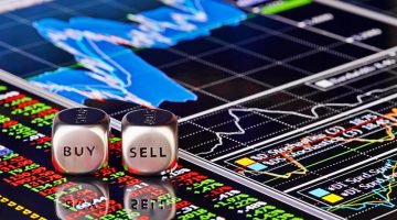 Cubes with the words SELL BUY on financial chart