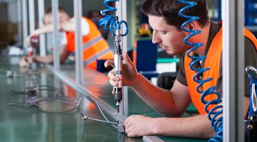 Men during precision work on production line