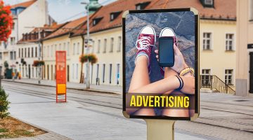 Billboard with advertising of a teenage girl with cellphone.
